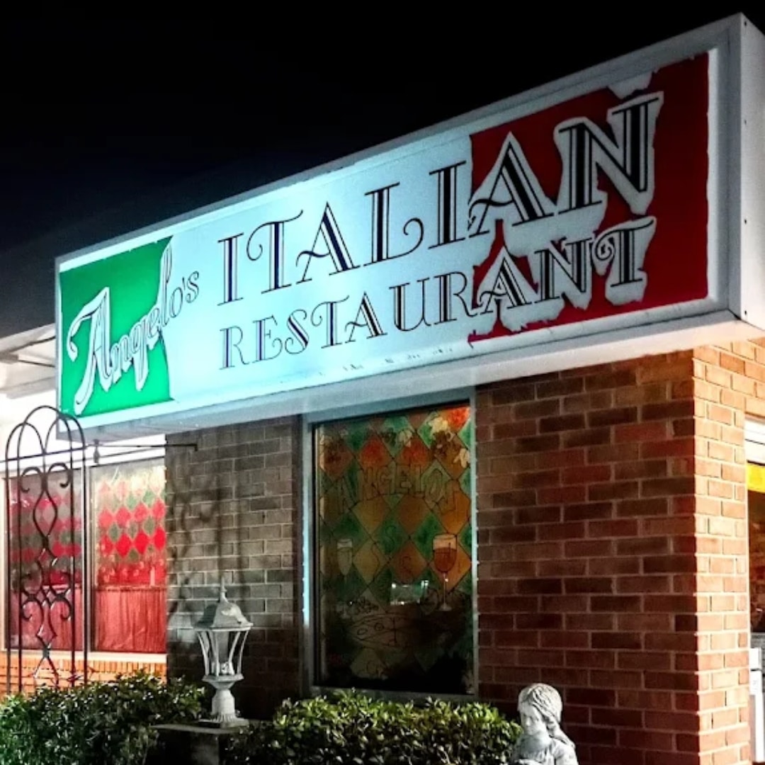 Exterior of Angelo's Restaurant with lighted sign on Italian Flag background