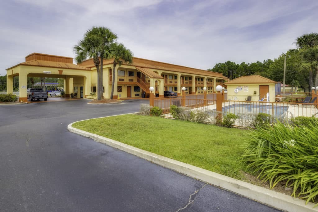 Econo Lodge Exterior with view of the pool from the southeast side of the building