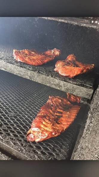 Chicken and ribs on a grill at Malson's BBQ