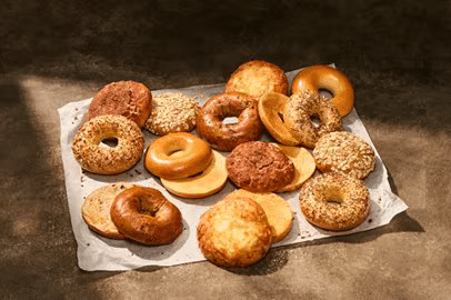 Baker's dozen variety of sliced bagels on parchment paper from Panera Bread