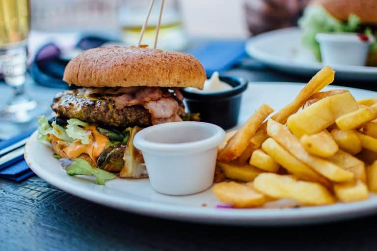 Bacon burger with thick cut French fries on a white plate at Ruby Tuesday