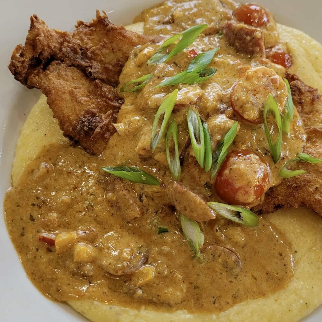 Cajun fried fish and grits in a bowl