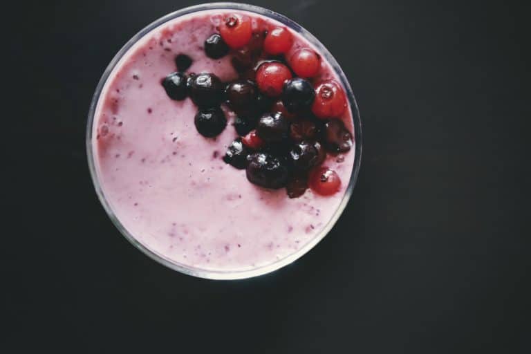Pink pomegranate and acai smoothie viewed from above