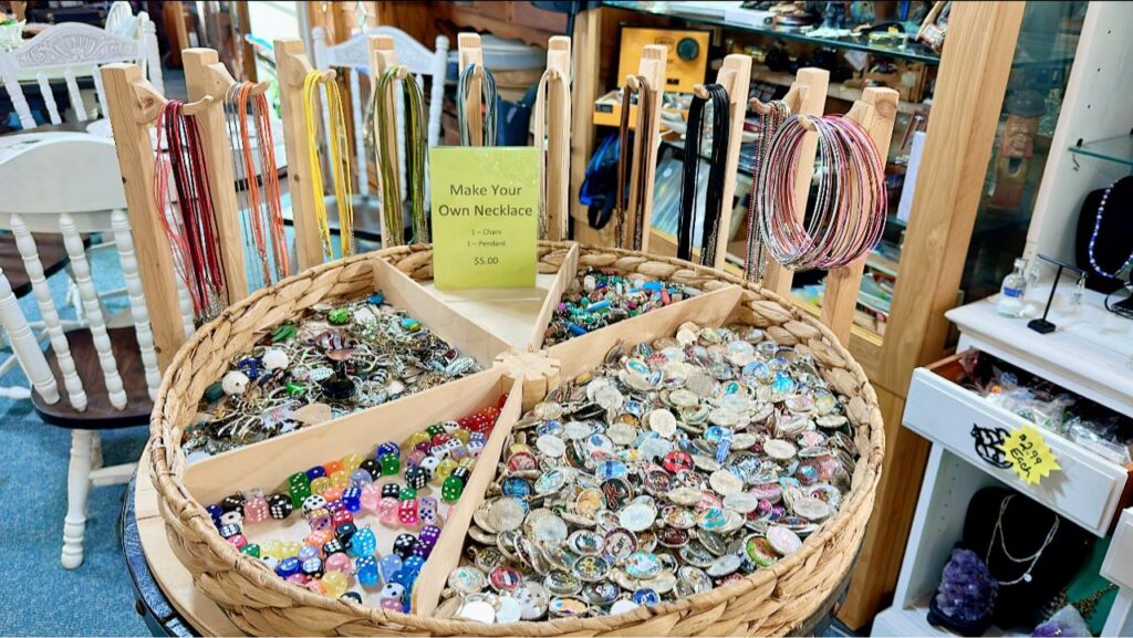 Beads in baskets and necklace cords for a make-your-own-necklace display