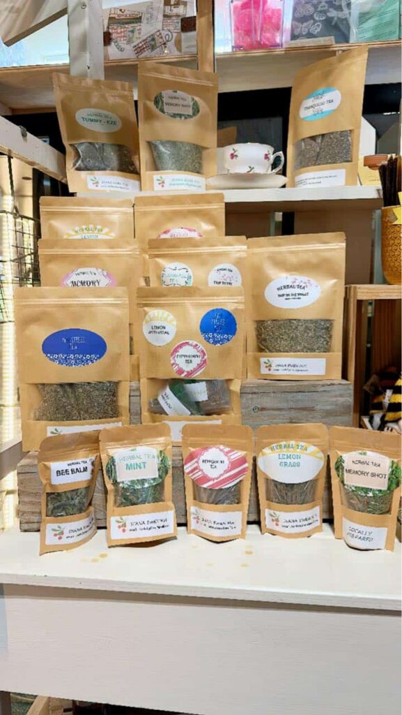 Display of loose tea leaves in brown kraft bags with clear windows