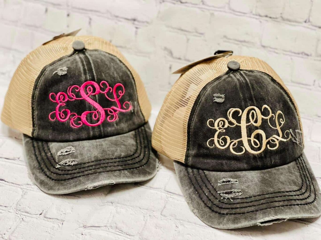 Two monogrammed baseball caps