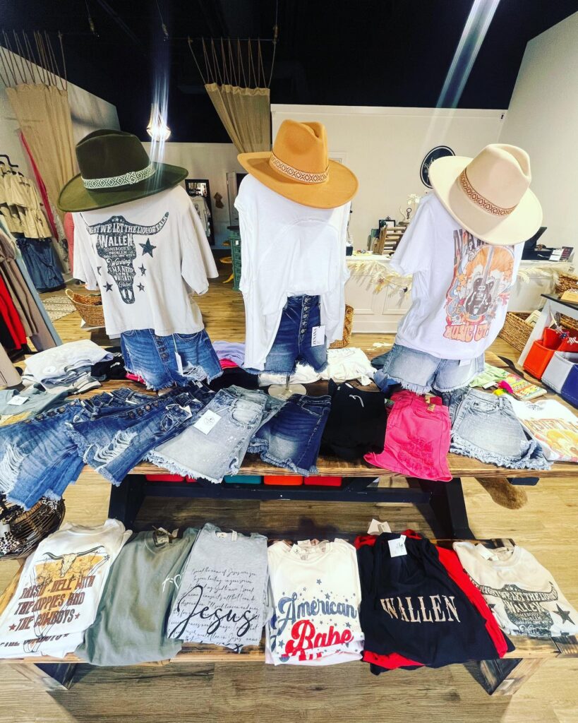 Display of T-shirts, cut-off denim shorts, and hats for sale