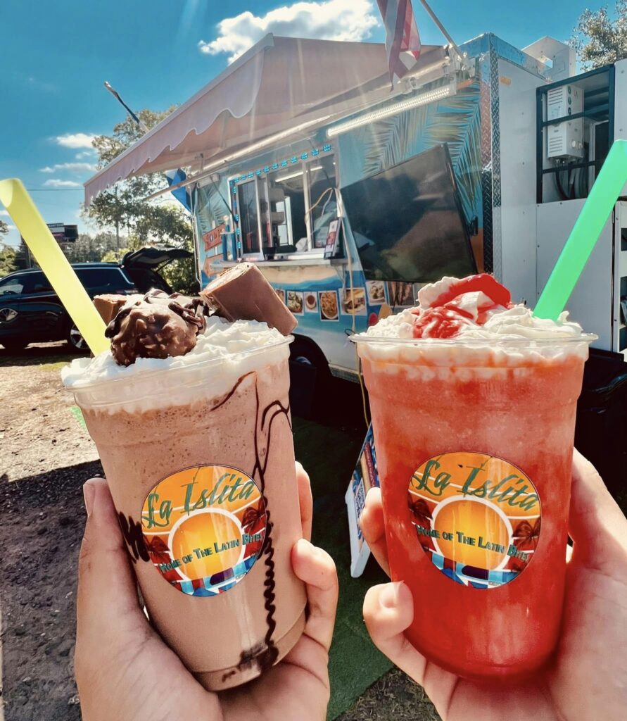 Two frozen specialty drinks--Nutella Frappe and Pina Colada--in clear branded cups from La Islita food truck