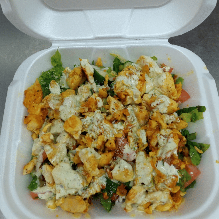 Gator Fish n chicken grilled chicken salad with romaine lettuce and wedge tomatoes, in an open white Styrofoam box