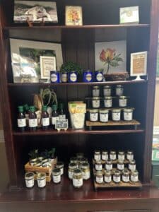Wooden hutch displaying scented candles, original artworks, jams, jellies, pickles and baking mixes from Georgia.