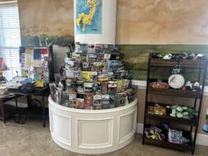Travel brochures displayed on a semi-circular, tired shelf under a map of Georgia's coast.
