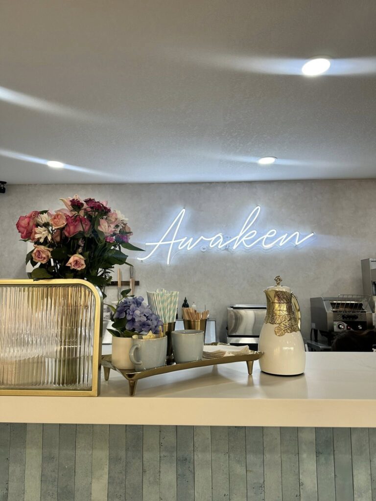 Awaken Coffee counter with flowers and coffee tray