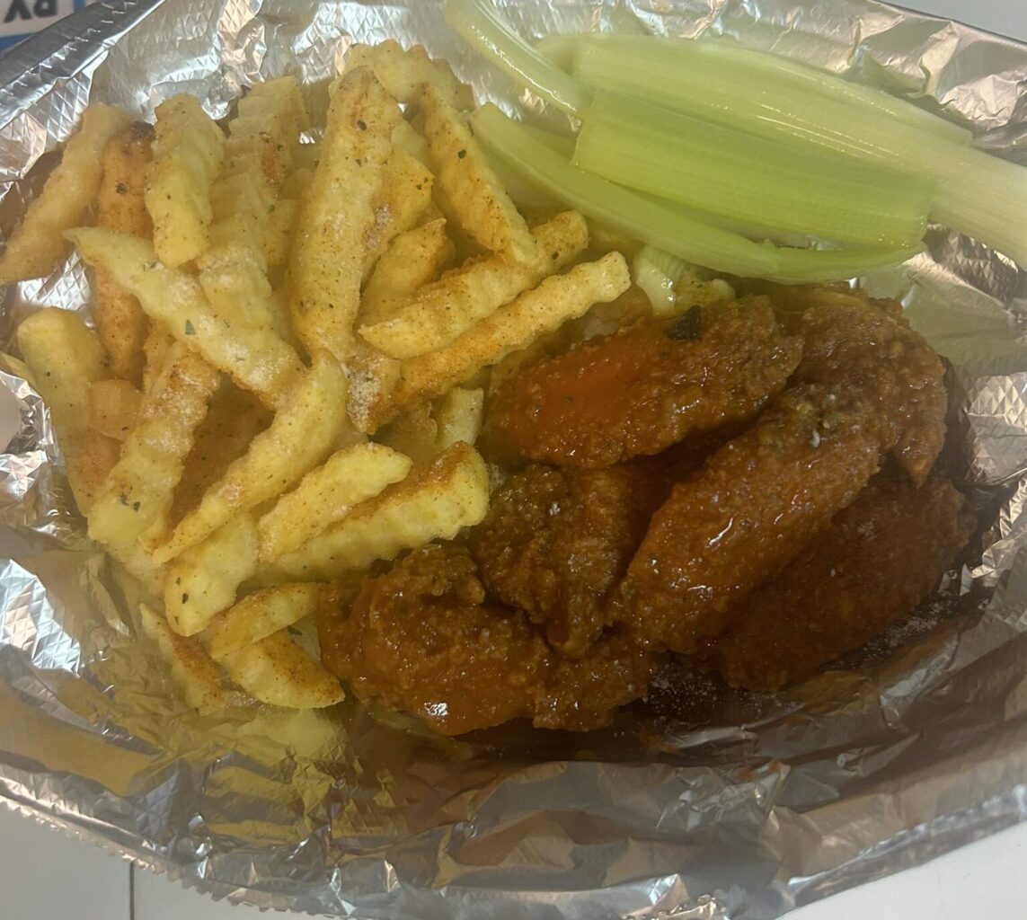 Chicken Wings meal with crinkle-cut French fries and celery sticks in an aluminum foil lined basket from Queen D's Court