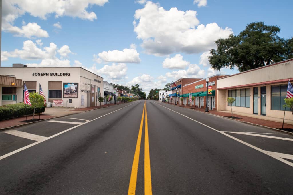 A view from the center double yellow line of US 17 (Lee St.) looking north from the intersection of Williams Ave. The Joseph Build is on the left and the Thiokol Museum is on the rightsection of