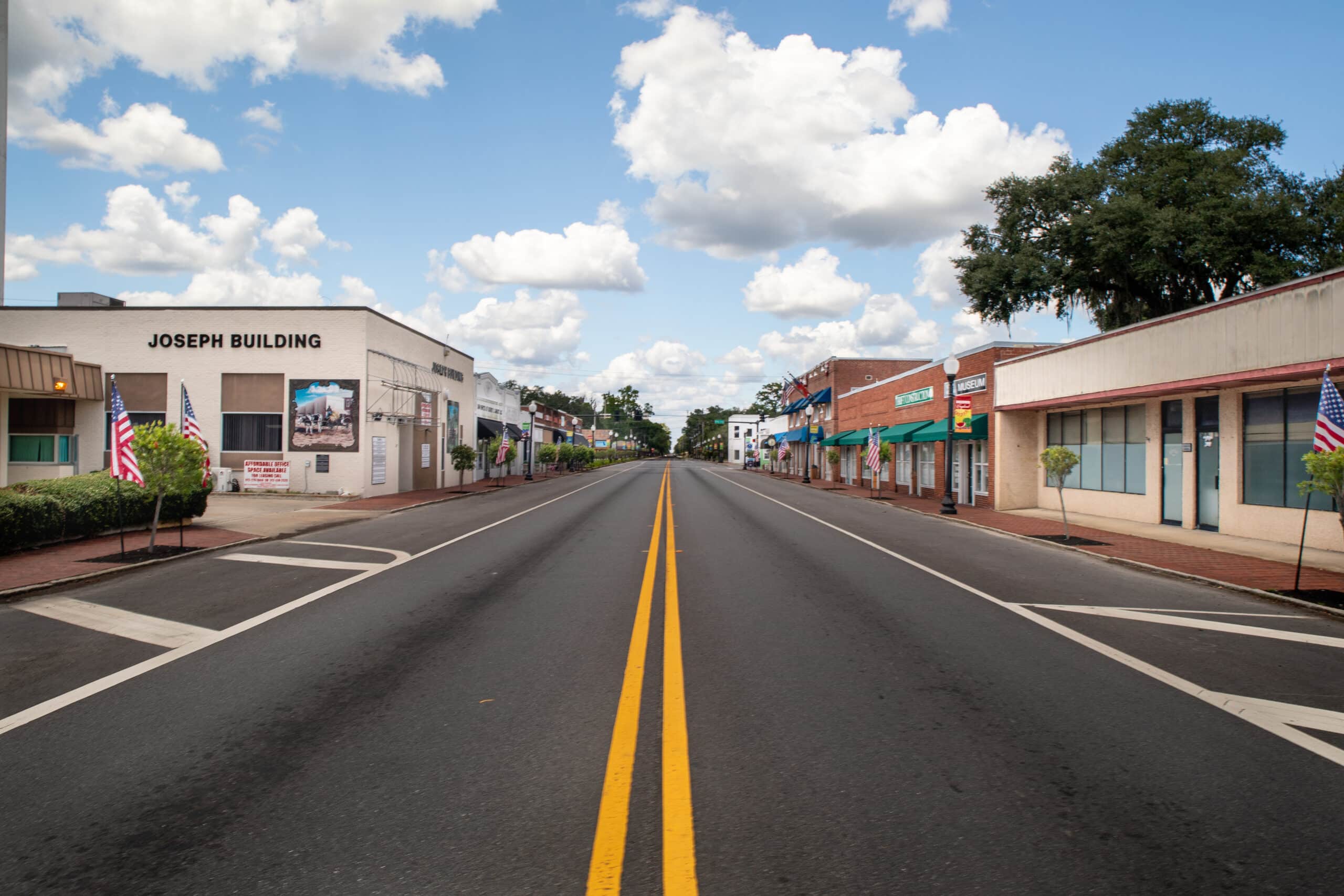 A view from the center double yellow line of US 17 (Lee St.) looking north from the intersection of Williams Ave. The Joseph Build is on the left and the Thiokol Museum is on the rightsection of