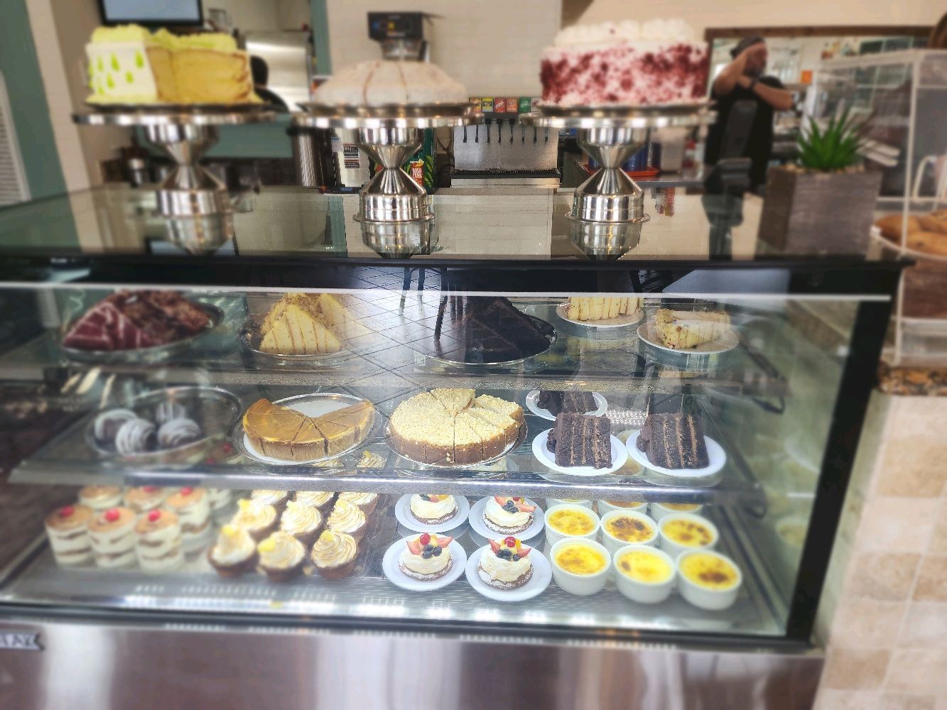 Refrigerated Bakery Case with a variety of individual desserts, pies, and cakes