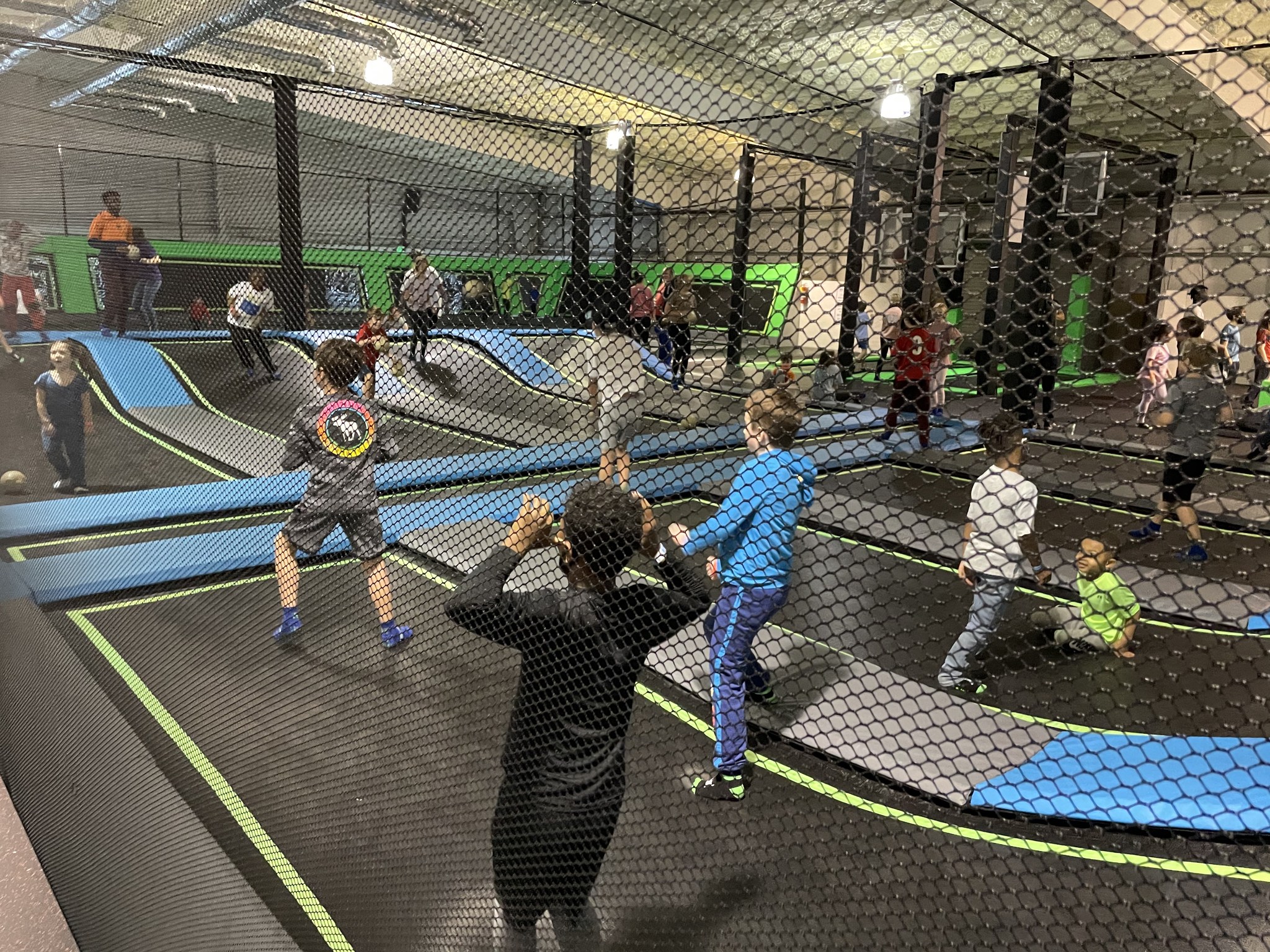 Kids playing trampoline dodge ball indoors