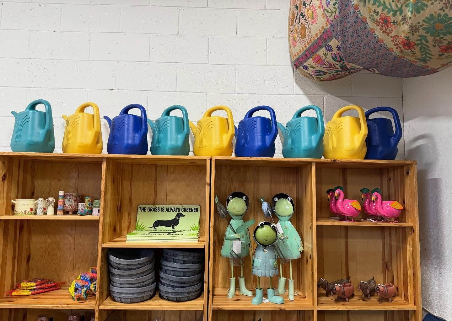 Inside merchandising display watering cans, whimsical pots and decor