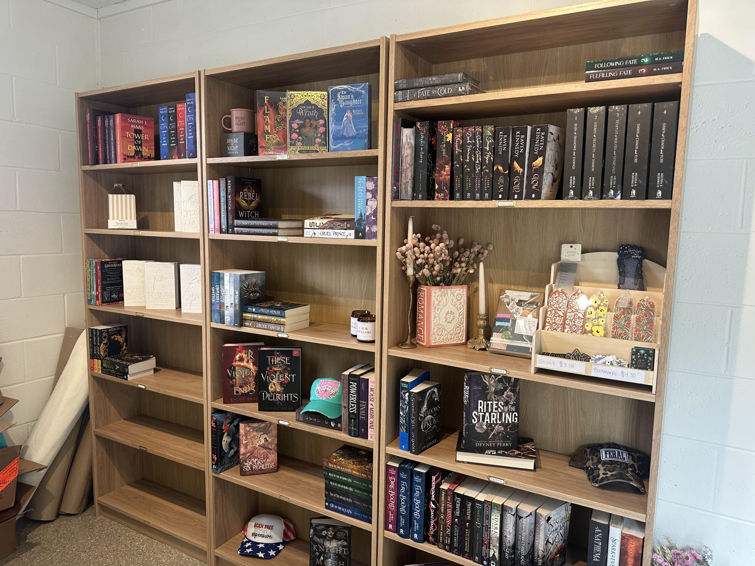 Three wooden Billy bookcases with books and gift items on display
