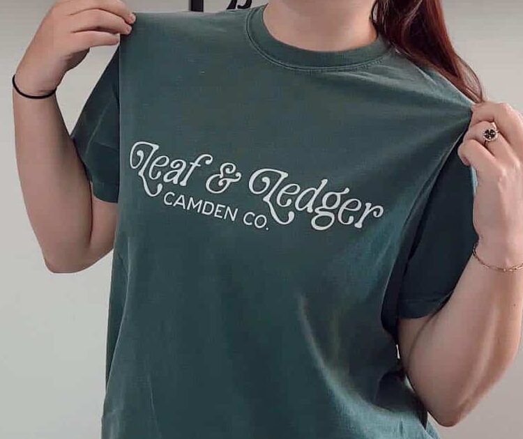Spruce green T-shirt with Leaf and Ledger branding in white