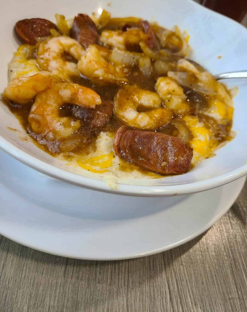 Shrimp and grits in a white bowl from Locals Dockside Restaurant