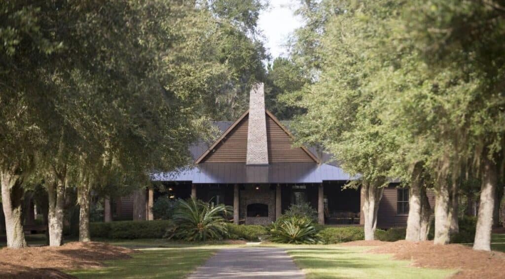 A paved drive leading to the Broadfield main lodge cabin