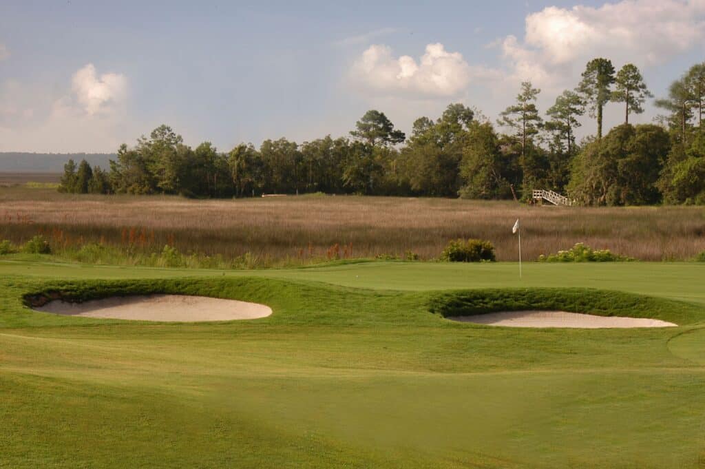 Two sand traps on a green at Osprey Cove Golf Club