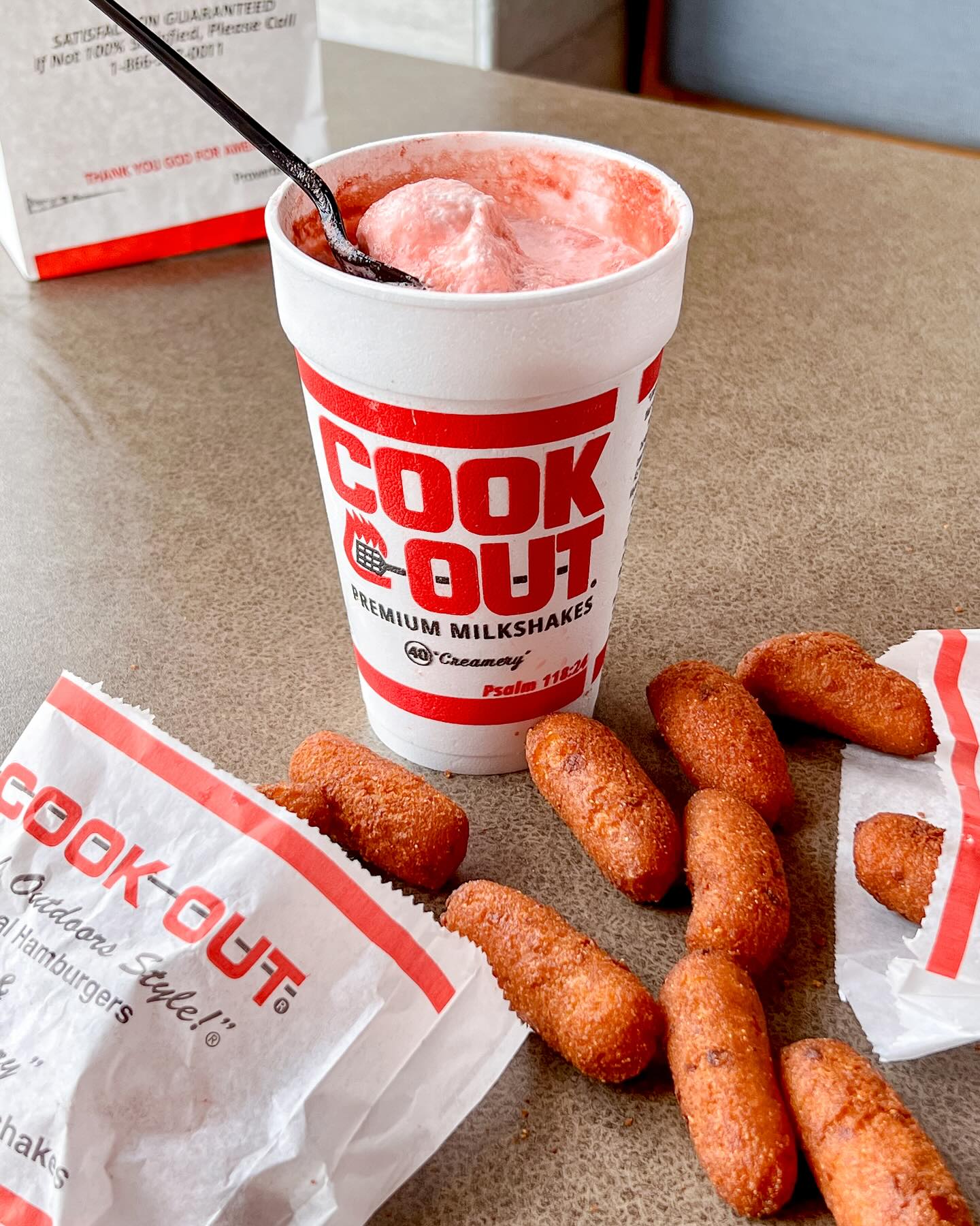 Cookout branded Styrofoam cup with a pink colored "Cheerwine" float and a side of huspuppies