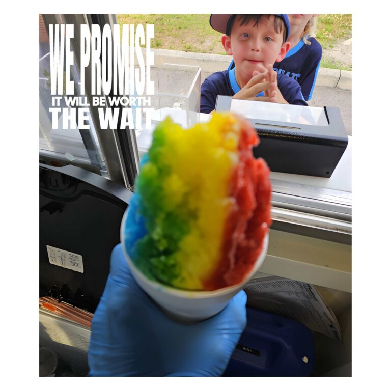 Rainbow color Hawaiian Shave Ice being served to a boy