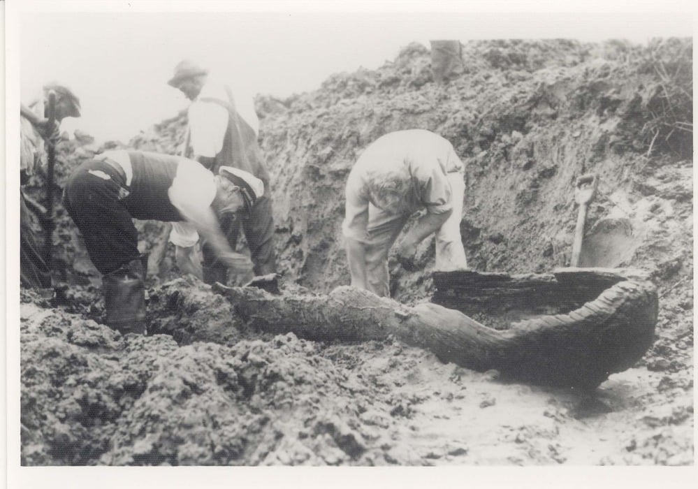 Archeologists uncovering a Timucuan canoe early 20th Century on Cumberland Island