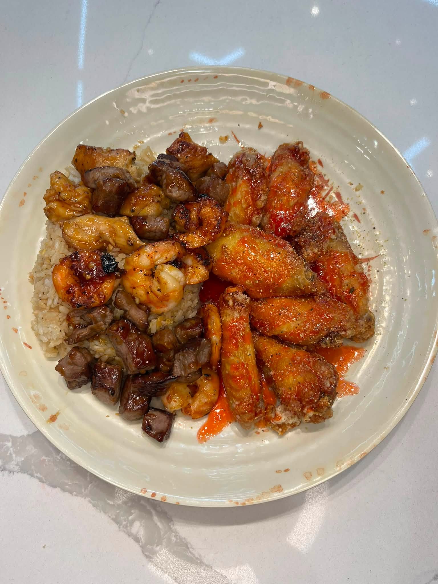 Hibachi chicken wings meal on a round white plate